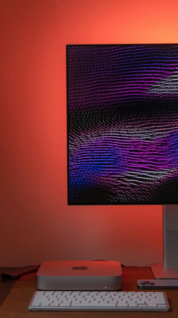 Stylish modern workspace featuring a computer, abstract monitor display, and keyboard.