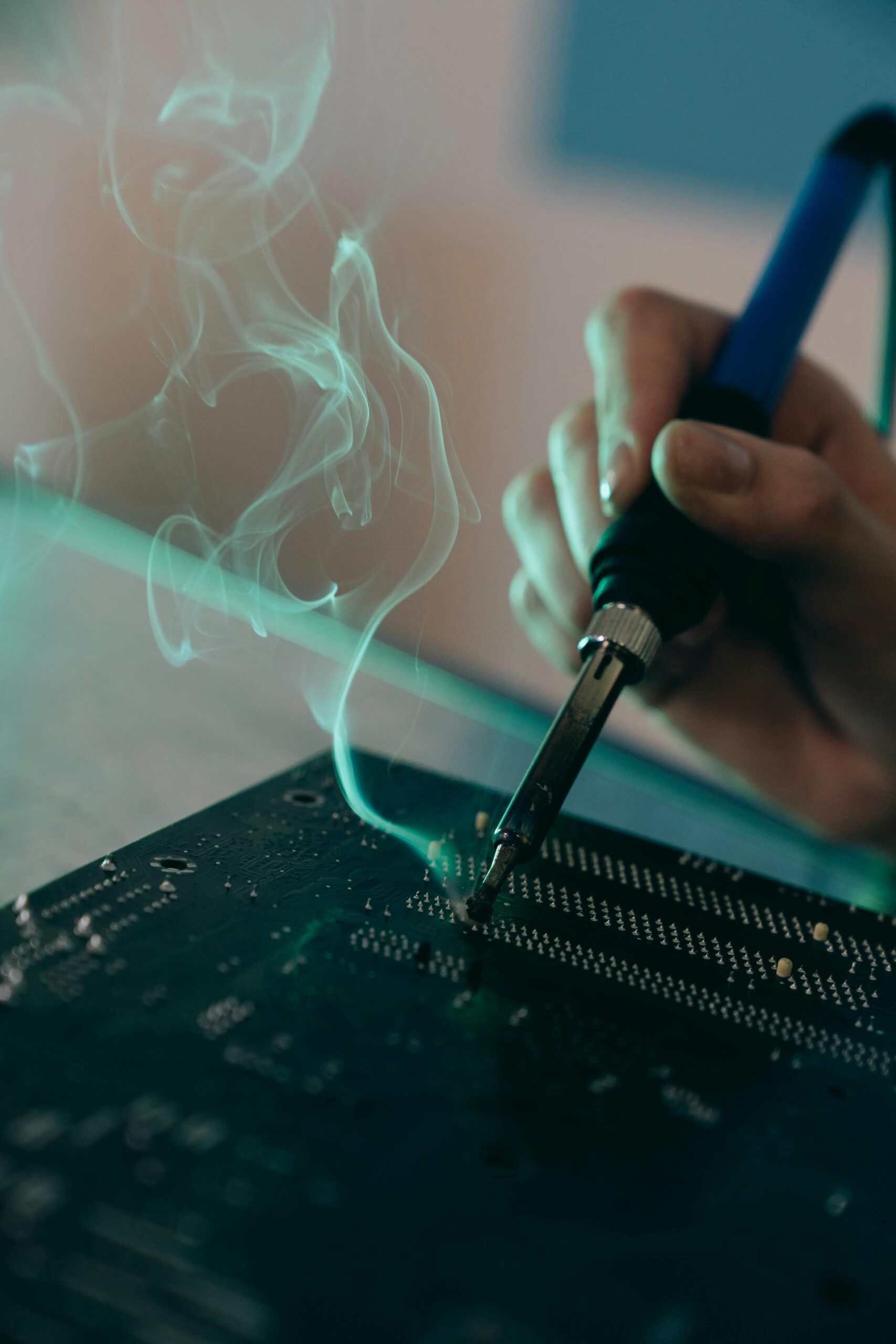 Detailed view of a person soldering a circuit board, capturing technology and engineering concepts.